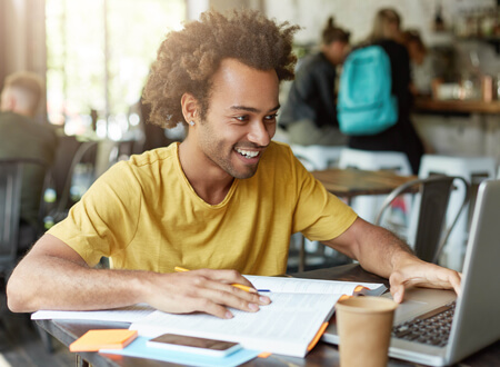 Man sat at laptop - For future growth - Open GI UK Benefits